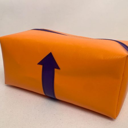 Kulturbeutel aus oranger Plane mit Pfeil